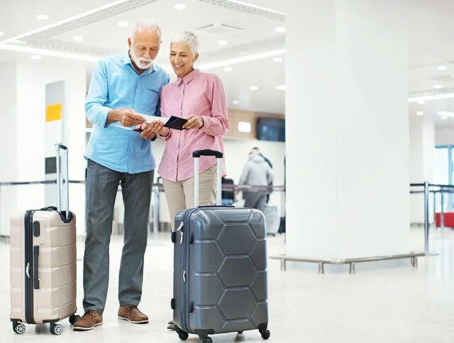 Seniors waiting for a check-in at an airport.