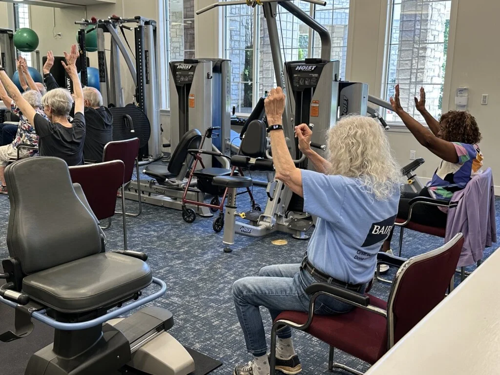 Residents taking part in a seated exercise class at Newcastle Place