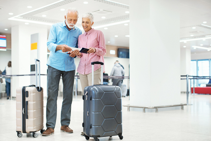 Seniors waiting for a check-in at an airport.