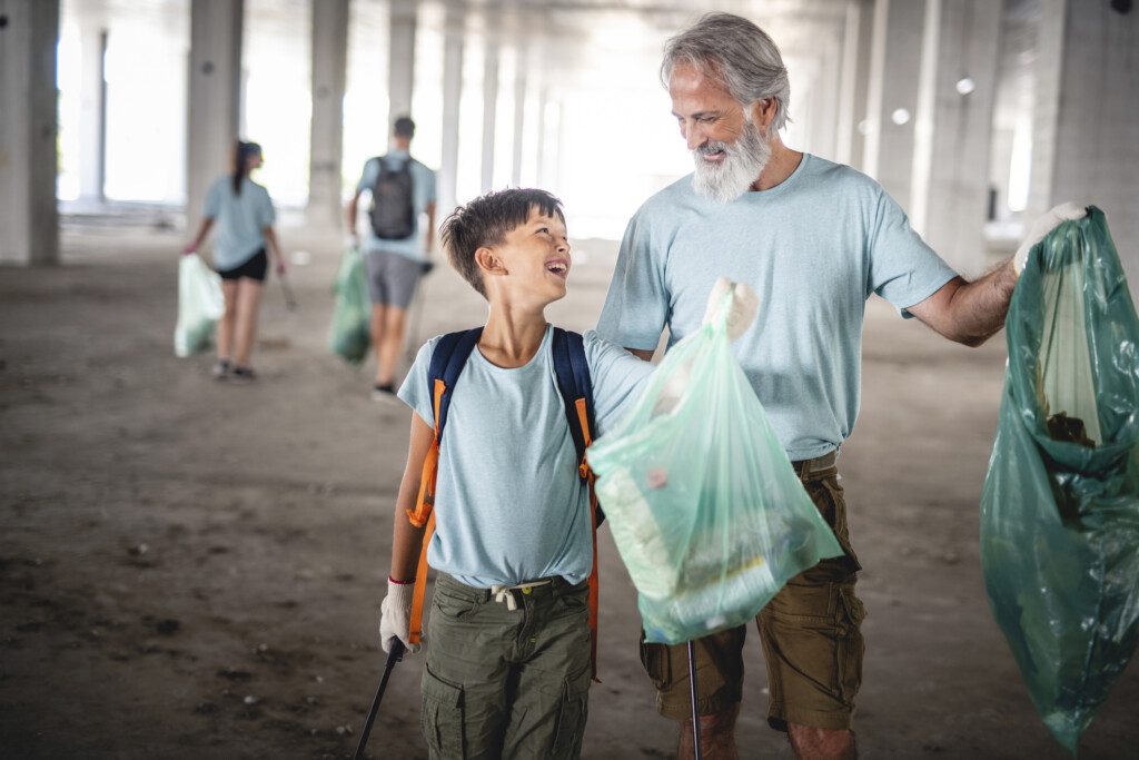 older man volunteering with a younger child
